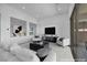 Bright living room with modern decor and through-wall opening to dining room at 6684 Regency Stone Way, Las Vegas, NV 89148
