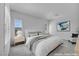 Bright bedroom features neutral decor, a large bed, and an adjacent sitting area at 6684 Regency Stone Way, Las Vegas, NV 89148