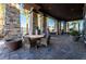 Charming outdoor seating area with stone columns, comfortable chairs, and a tranquil atmosphere at 6684 Regency Stone Way, Las Vegas, NV 89148