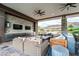 Comfortable outdoor seating with stone decor, ceiling fans, TVs, and views of the community at 6684 Regency Stone Way, Las Vegas, NV 89148