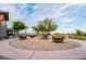 Pleasant outdoor seating with tables and chairs for socializing, complemented by lush landscaping at 6684 Regency Stone Way, Las Vegas, NV 89148
