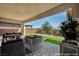 Inviting outdoor patio with stylish lounge furniture and manicured landscaping at 6684 Regency Stone Way, Las Vegas, NV 89148