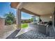 Covered patio with lounge seating and gravel landscaping at 6684 Regency Stone Way, Las Vegas, NV 89148