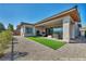 Outdoor patio with turf and lounge seating at 6684 Regency Stone Way, Las Vegas, NV 89148