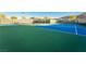 Brightly colored tennis court offers green and blue surfaces with shaded benches for relaxing between games at 6684 Regency Stone Way, Las Vegas, NV 89148
