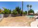 Large backyard features palm trees, inground pool, and lots of space at 6710 Rocking Horse Ave, Las Vegas, NV 89108