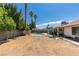 Large backyard features palm trees, inground pool, and lots of space at 6710 Rocking Horse Ave, Las Vegas, NV 89108