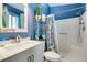 Bathroom features vanity, sink, mirror, toilet and shower with a glass door at 6710 Rocking Horse Ave, Las Vegas, NV 89108