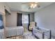 Bedroom with ceiling fan, large mirror, natural light at 6710 Rocking Horse Ave, Las Vegas, NV 89108