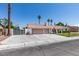 Charming single-story home with an attached three-car garage and well-maintained front yard with lush landscaping at 6710 Rocking Horse Ave, Las Vegas, NV 89108