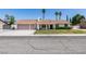 Charming single-story home with a two-car garage, well-maintained lawn, mature trees, and a welcoming front porch enhancing its curb appeal at 6710 Rocking Horse Ave, Las Vegas, NV 89108