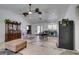 Spacious living room featuring high ceilings, ceiling fans, and ample natural light from a large window at 6710 Rocking Horse Ave, Las Vegas, NV 89108