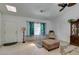 Welcoming living room with a skylight, neutral walls, ceiling fans and hardwood floors at 6710 Rocking Horse Ave, Las Vegas, NV 89108