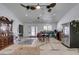 Spacious living room and kitchen area with neutral walls, ceiling fans and hardwood floors at 6710 Rocking Horse Ave, Las Vegas, NV 89108