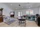 Inviting living room and kitchen area with neutral walls, ceiling fans and hardwood floors at 6710 Rocking Horse Ave, Las Vegas, NV 89108
