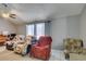 Cozy living room featuring comfortable seating, a ceiling fan, and natural light from the windows at 6710 Rocking Horse Ave, Las Vegas, NV 89108