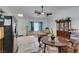 Bright kitchen and dining area with stainless steel appliances, light countertops and white walls at 6710 Rocking Horse Ave, Las Vegas, NV 89108
