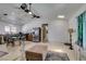 Bright living room and kitchen area with neutral walls, ceiling fans and hardwood floors at 6710 Rocking Horse Ave, Las Vegas, NV 89108