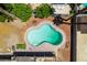 An aerial view of a freeform swimming pool surrounded by a concrete patio at 6710 Rocking Horse Ave, Las Vegas, NV 89108