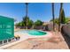 Backyard features a kidney-shaped pool and tall palm trees at 6710 Rocking Horse Ave, Las Vegas, NV 89108
