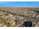 A high aerial view shows the house in a neighborhood surrounded by mature landscaping and distant mountains at 6804 Tropicaire St, Las Vegas, NV 89149