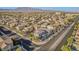 An aerial view of the residential area, with many homes, trees, and mountains in the background at 6804 Tropicaire St, Las Vegas, NV 89149