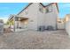 The backyard features gravel landscaping with a covered patio and modern AC units at 6804 Tropicaire St, Las Vegas, NV 89149