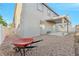 A spacious backyard featuring gravel landscaping, a covered patio, and a low-maintenance design at 6804 Tropicaire St, Las Vegas, NV 89149