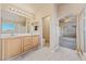 Bright bathroom features double sinks, neutral tiling, and a glass-enclosed shower at 6804 Tropicaire St, Las Vegas, NV 89149