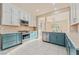 Well-equipped kitchen featuring stainless steel appliances, gas range, white upper and blue lower cabinets at 6804 Tropicaire St, Las Vegas, NV 89149