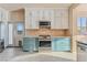 Bright kitchen features stainless steel appliances, blue cabinets, granite countertops, and lots of storage at 6804 Tropicaire St, Las Vegas, NV 89149