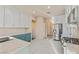 Modern kitchen with white cabinetry, stainless appliances, a tile floor, and blue lower cabinets at 6804 Tropicaire St, Las Vegas, NV 89149