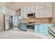 Stylish kitchen featuring stainless steel appliances, gas range, white upper and blue lower cabinets at 6804 Tropicaire St, Las Vegas, NV 89149