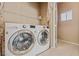 Practical laundry room featuring a side-by-side washer and dryer at 6804 Tropicaire St, Las Vegas, NV 89149