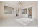 Open-concept living room provides views into the kitchen and ample natural light from large windows at 6804 Tropicaire St, Las Vegas, NV 89149