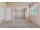 Open living room with lots of light, neutral carpet, and views to another room at 6804 Tropicaire St, Las Vegas, NV 89149