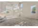Spacious living room with a staircase, neutral-colored carpet, and sunlit windows overlooking the neighborhood at 6804 Tropicaire St, Las Vegas, NV 89149
