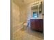 A practical bathroom with a tub, toilet, and vanity with a modern sink at 7469 Margollini St, Las Vegas, NV 89148