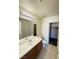 Bathroom with tile flooring, and a vanity with good storage and a large well lit mirror at 7469 Margollini St, Las Vegas, NV 89148