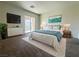 Bright bedroom featuring a sliding glass door to a balcony and neutral decor at 7469 Margollini St, Las Vegas, NV 89148