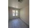 Bright bedroom with gray flooring, two large windows, and fresh paint at 7469 Margollini St, Las Vegas, NV 89148