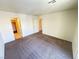 Large bedroom with neutral walls, plush carpeting, and multiple doorways at 7469 Margollini St, Las Vegas, NV 89148