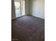 A simple bedroom featuring a large closet and a balcony overlooking the neighborhood at 7469 Margollini St, Las Vegas, NV 89148