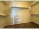 Empty closet with a carpeted floor and white shelving and rods at 7469 Margollini St, Las Vegas, NV 89148