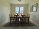 Inviting dining room with a wooden table, six chairs, and elegant decor, creating a cozy ambiance at 7469 Margollini St, Las Vegas, NV 89148