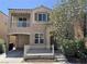 Two-story home featuring a balcony, covered parking, and well-maintained landscaping at 7469 Margollini St, Las Vegas, NV 89148