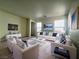 Bright, comfortable living room with large windows and modern decor for relaxation and entertainment at 7469 Margollini St, Las Vegas, NV 89148