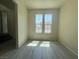 Bright living room with gray wood-look floors and large windows, perfect for creating a cozy and inviting atmosphere at 7469 Margollini St, Las Vegas, NV 89148