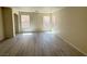 A spacious living room with light-colored walls and modern gray flooring at 7469 Margollini St, Las Vegas, NV 89148