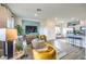 Open-concept living room adjacent to a kitchen, furnished with modern decor, and bathed in natural light at 7925 Pandora Sky St # 392, Las Vegas, NV 89084